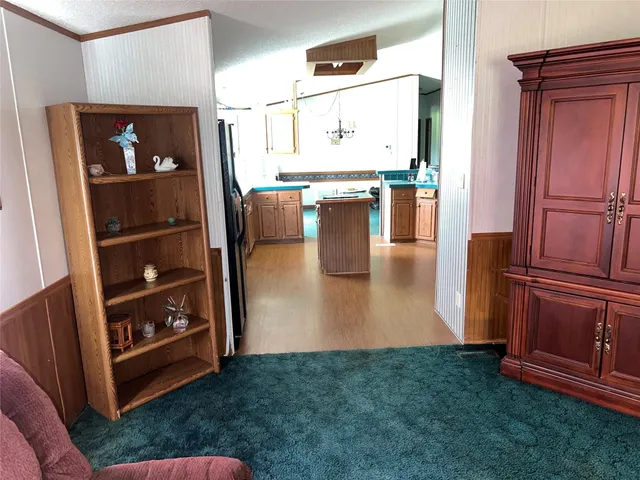a view of kitchen with furniture and refrigerator