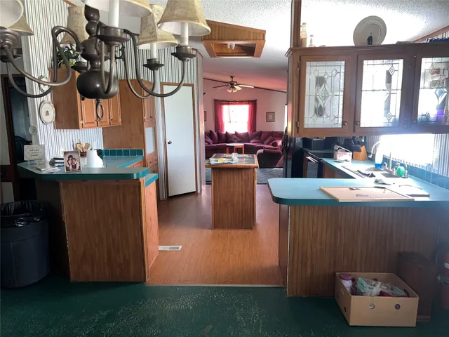a living room with furniture and a kitchen view