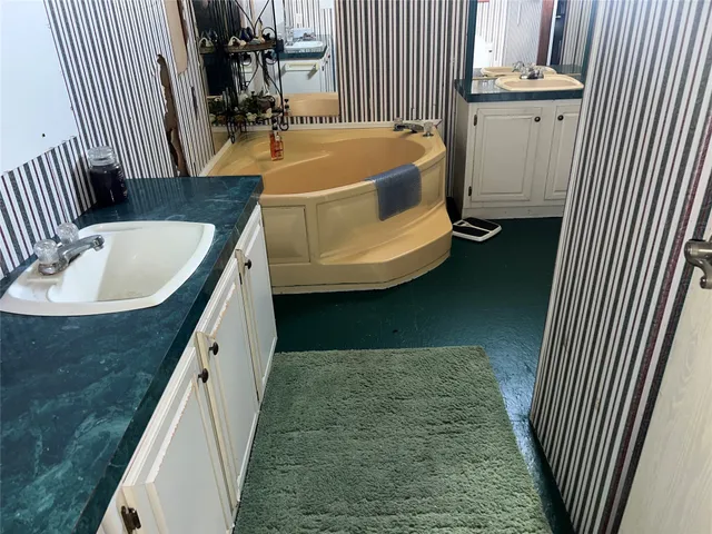 a bathroom with a sink and mirror