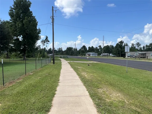 a view of swimming pool is middle in the garden