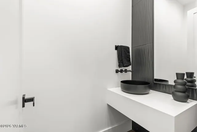 a view of a hallway with wooden floor and windows