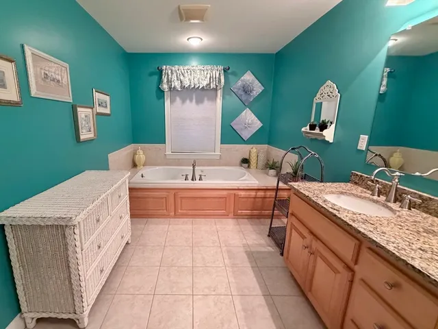 a spacious bathroom with a sink and a large mirror