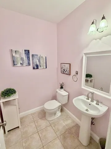 a bathroom with a sink toilet and a mirror
