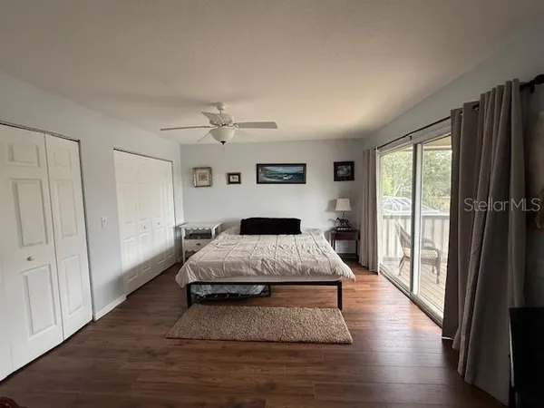 a spacious bedroom with a bed and a large window