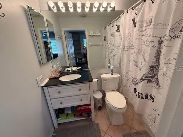 a bathroom with a toilet a sink and a mirror