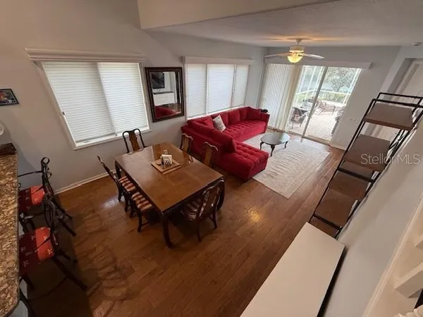 a living room with furniture and a wooden floor