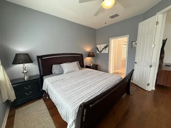 a bedroom with a bed and a lamp