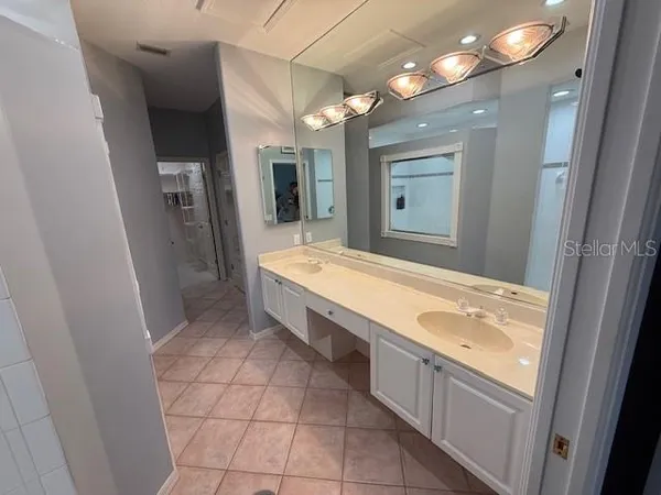 a bathroom with a granite countertop sink mirror and bathtub