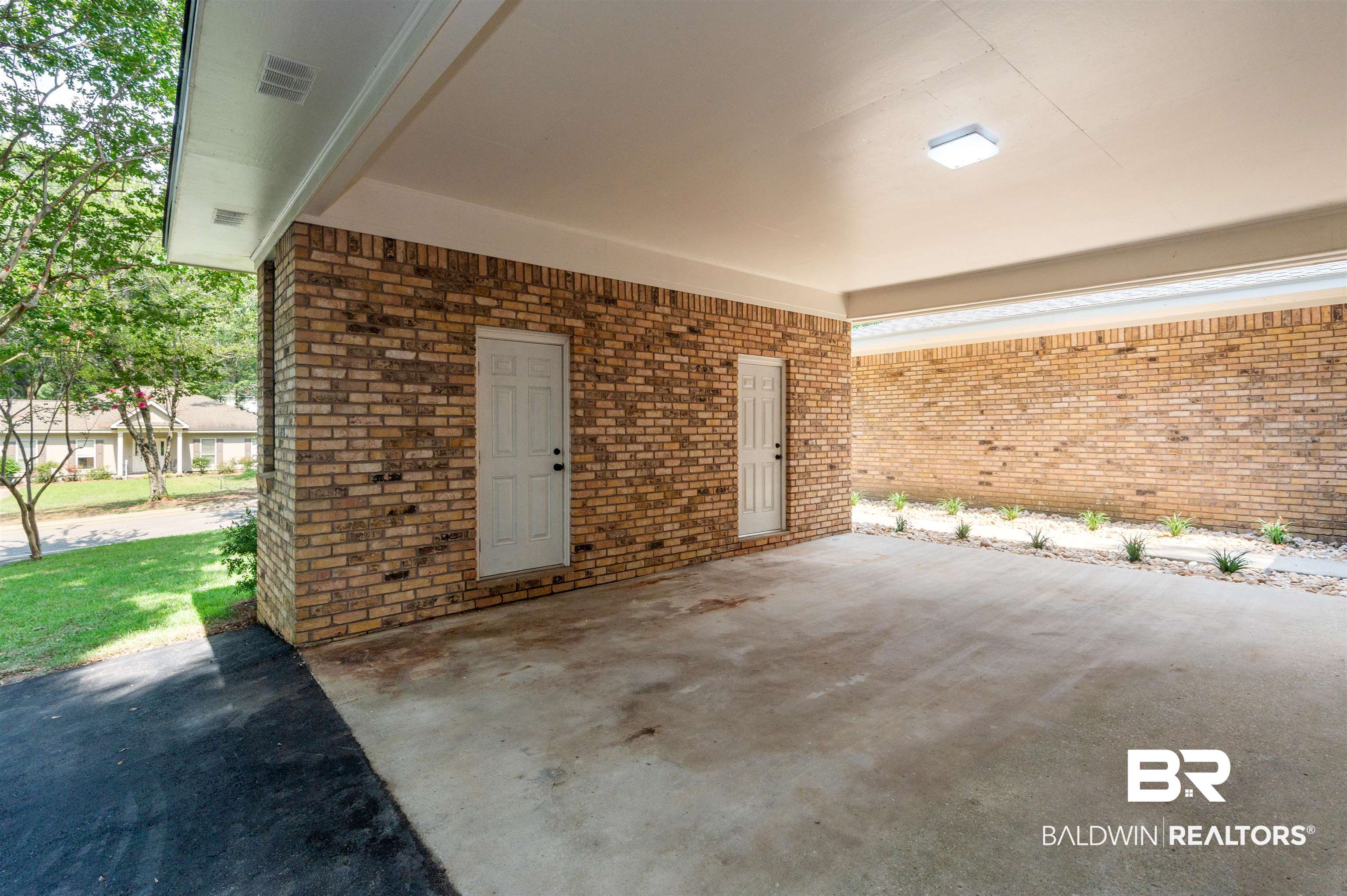 599 Ridgewood Drive Daphne, AL 36526 - Photo 26 of 41 Carport featuring brick construction and a concrete floor