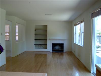 10 Wild Rye Way Napa, CA 94558 - Photo 5 of 8 an empty room with windows fireplace and wooden floor
