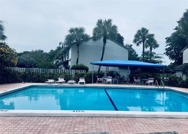 a view of a swimming pool with sitting area