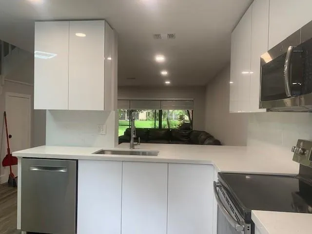 a kitchen with a sink and a stove top oven