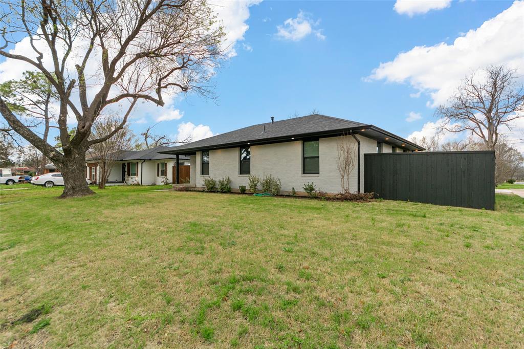 2945 Healey Drive Dallas, TX 75228 - Photo 32 of 38 a front view of house with yard and trees in the background