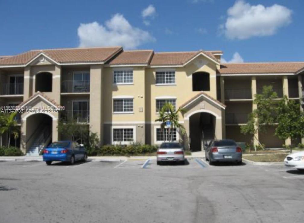 15480 Southwest 284th Street, Unit 2304 Homestead, FL 33033 - Photo 22 of 31 a front view of a house with cars parked