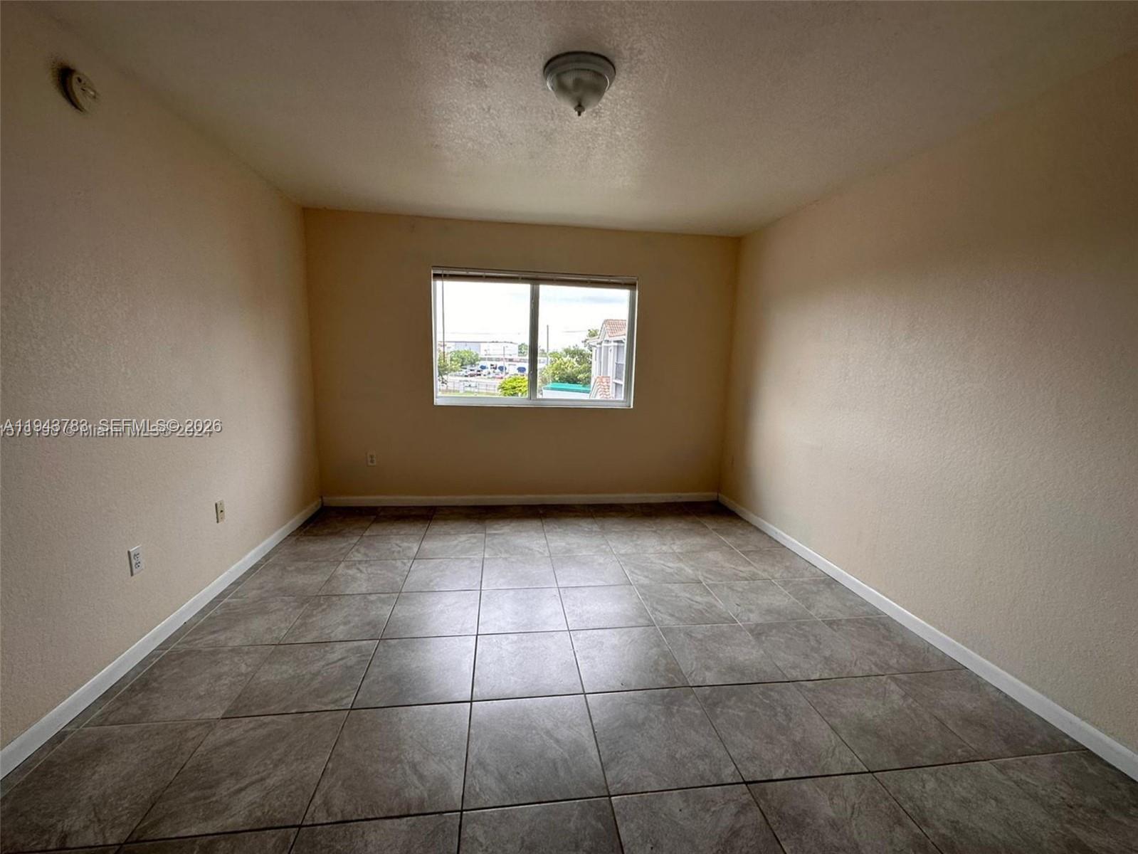 15480 Southwest 284th Street, Unit 2304 Homestead, FL 33033 - Photo 7 of 31 a view of an empty room with a window