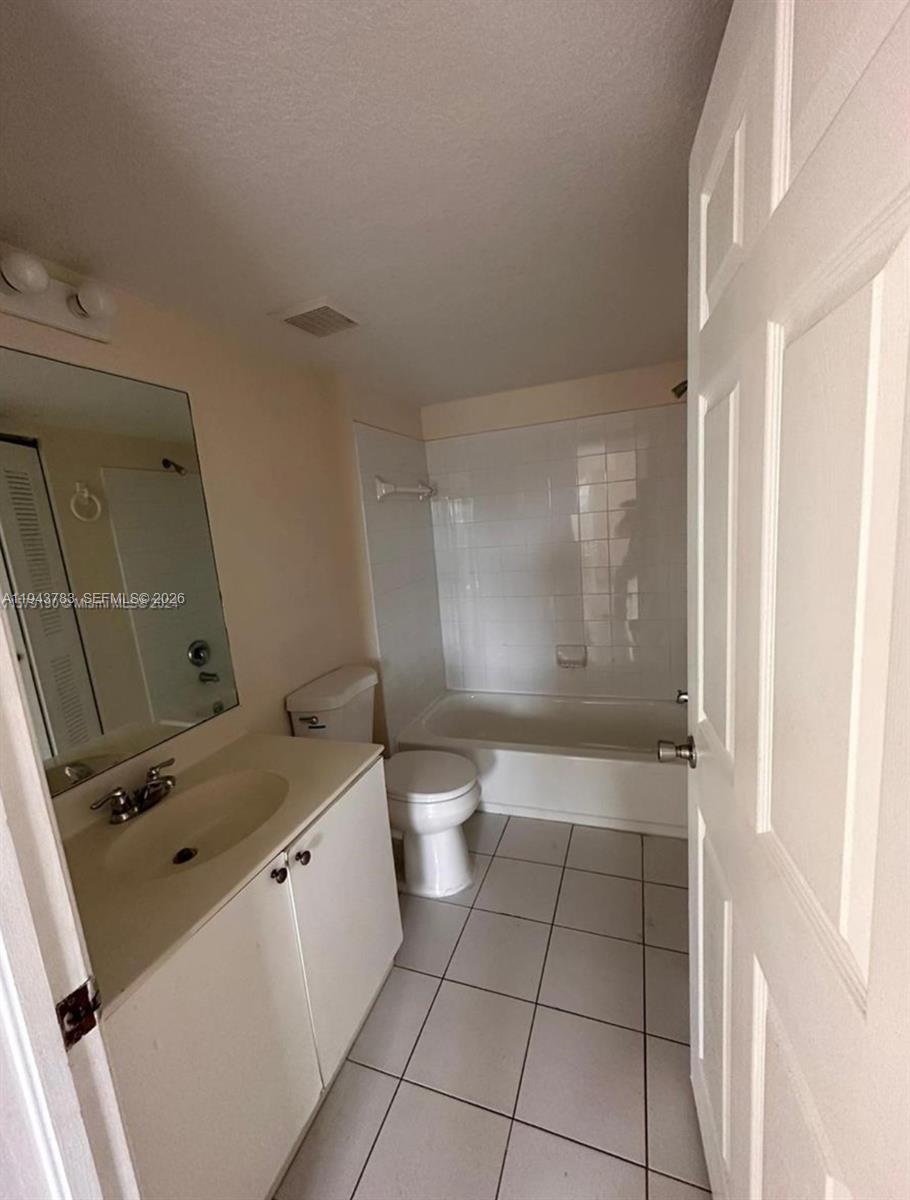 15480 Southwest 284th Street, Unit 2304 Homestead, FL 33033 - Photo 10 of 31 a bathroom with a granite countertop sink toilet and shower