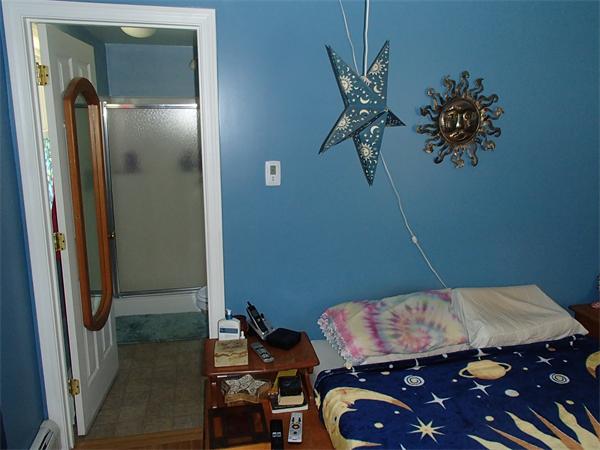 24 Ed Clark Road Colrain, MA 01340 - Photo 21 of 25 a bedroom with a bed and a chandelier