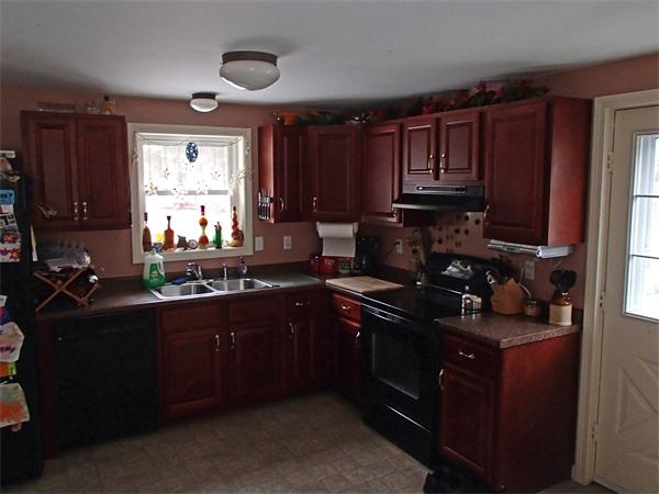 24 Ed Clark Road Colrain, MA 01340 - Photo 9 of 25 a kitchen with black cabinets and black appliances