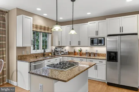 a kitchen with a stove a refrigerator and a dining table