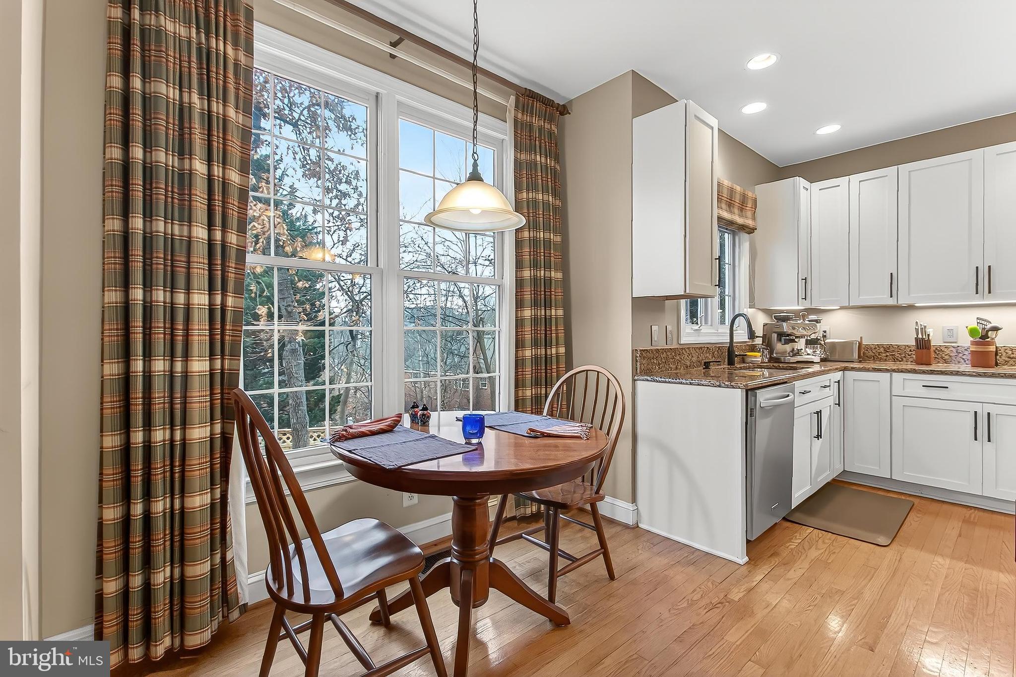 4818 9th Street South Arlington, VA 22204 - Photo 21 of 57 a kitchen with a dining table chairs and refrigerator