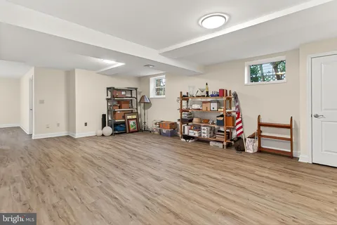 a view of a room with wooden floor and a window