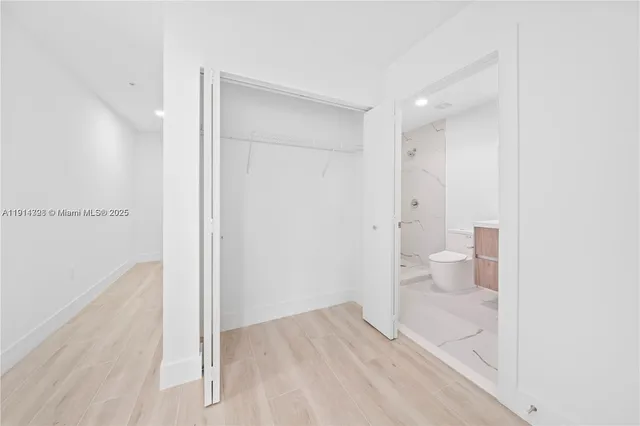 a bathroom with a glass shower door