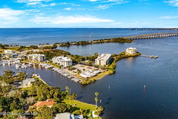 an aerial view of a houses with ocean view