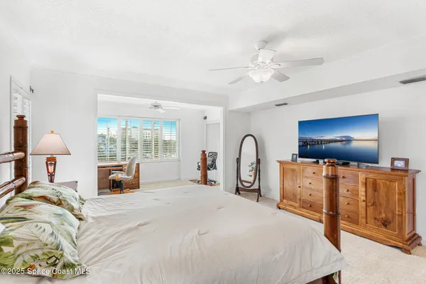 a bed room with furniture and a flat screen tv