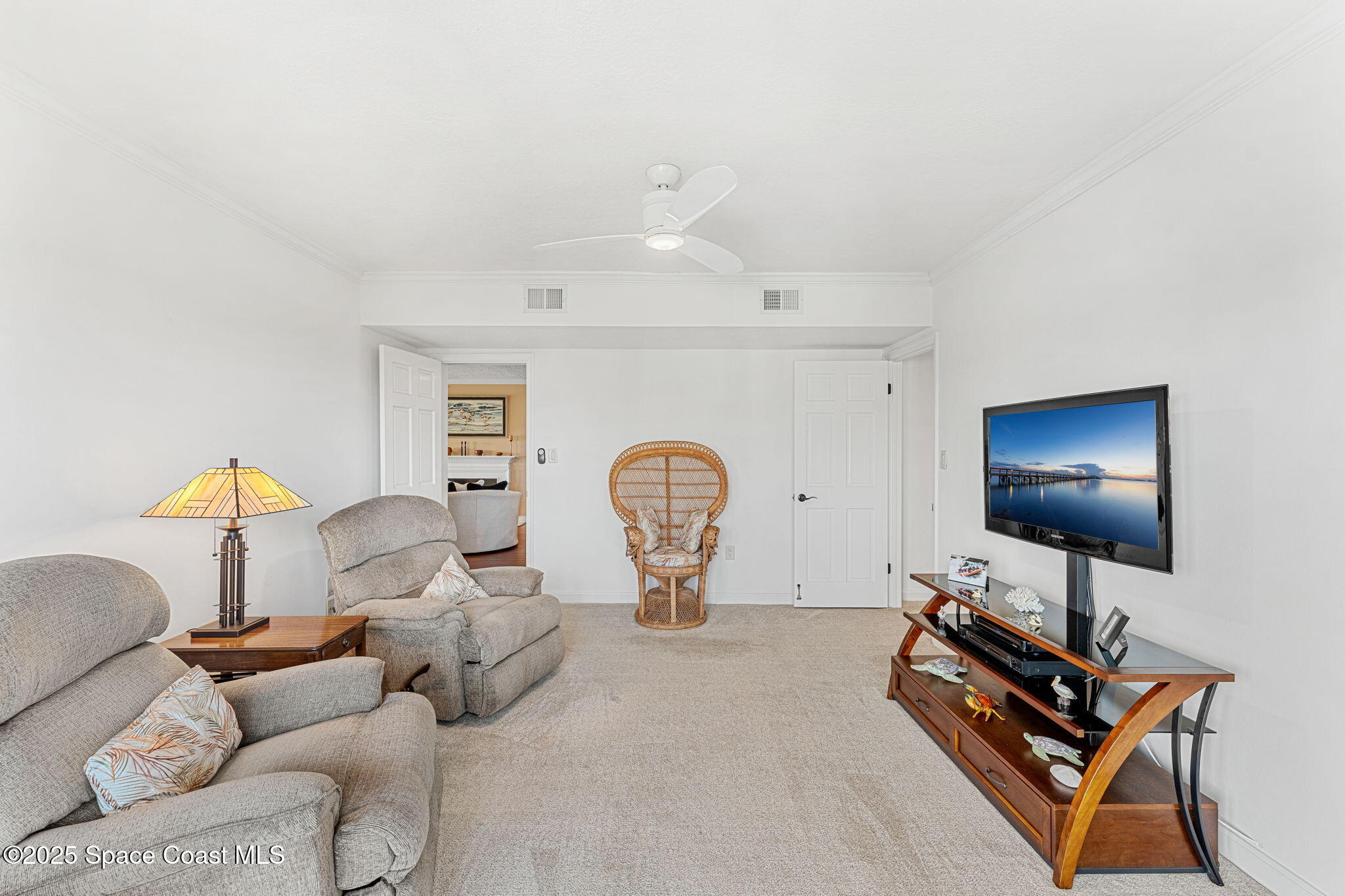 2220 Front Street, Unit 404 Melbourne, FL 32901 - Photo 39 of 51 a living room with furniture a flat screen tv and gym equipment
