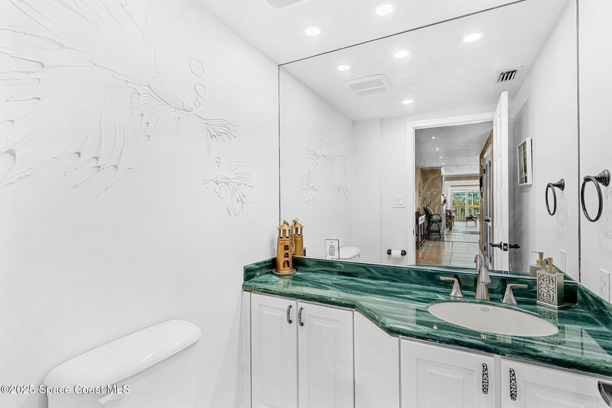 2220 Front Street, Unit 404 Melbourne, FL 32901 - Photo 46 of 51 a bathroom with a granite countertop sink and a mirror