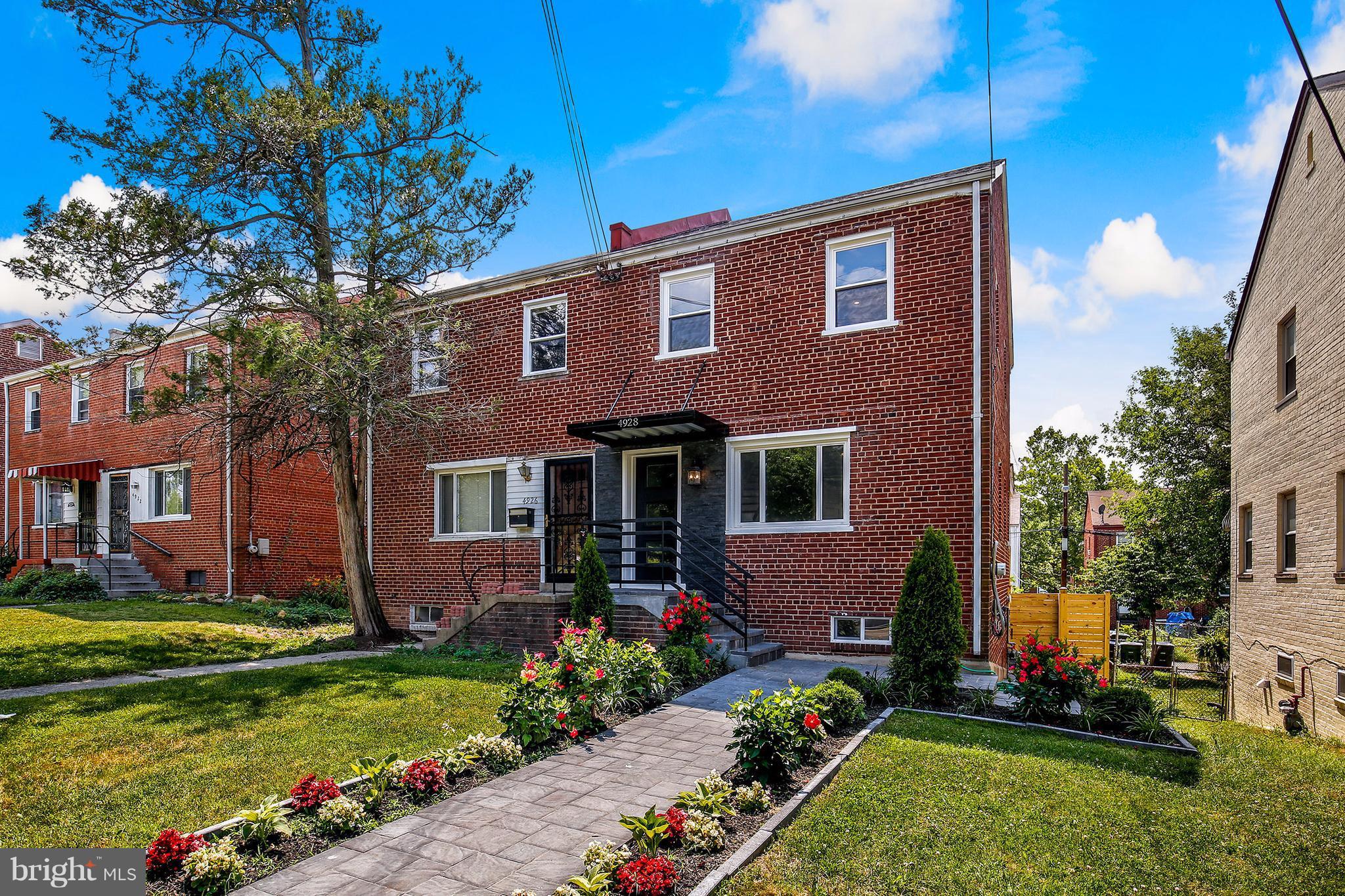 4928 Sargent Road Northeast Washington, DC 20017 - Photo 1 of 30 a front view of a house with a yard