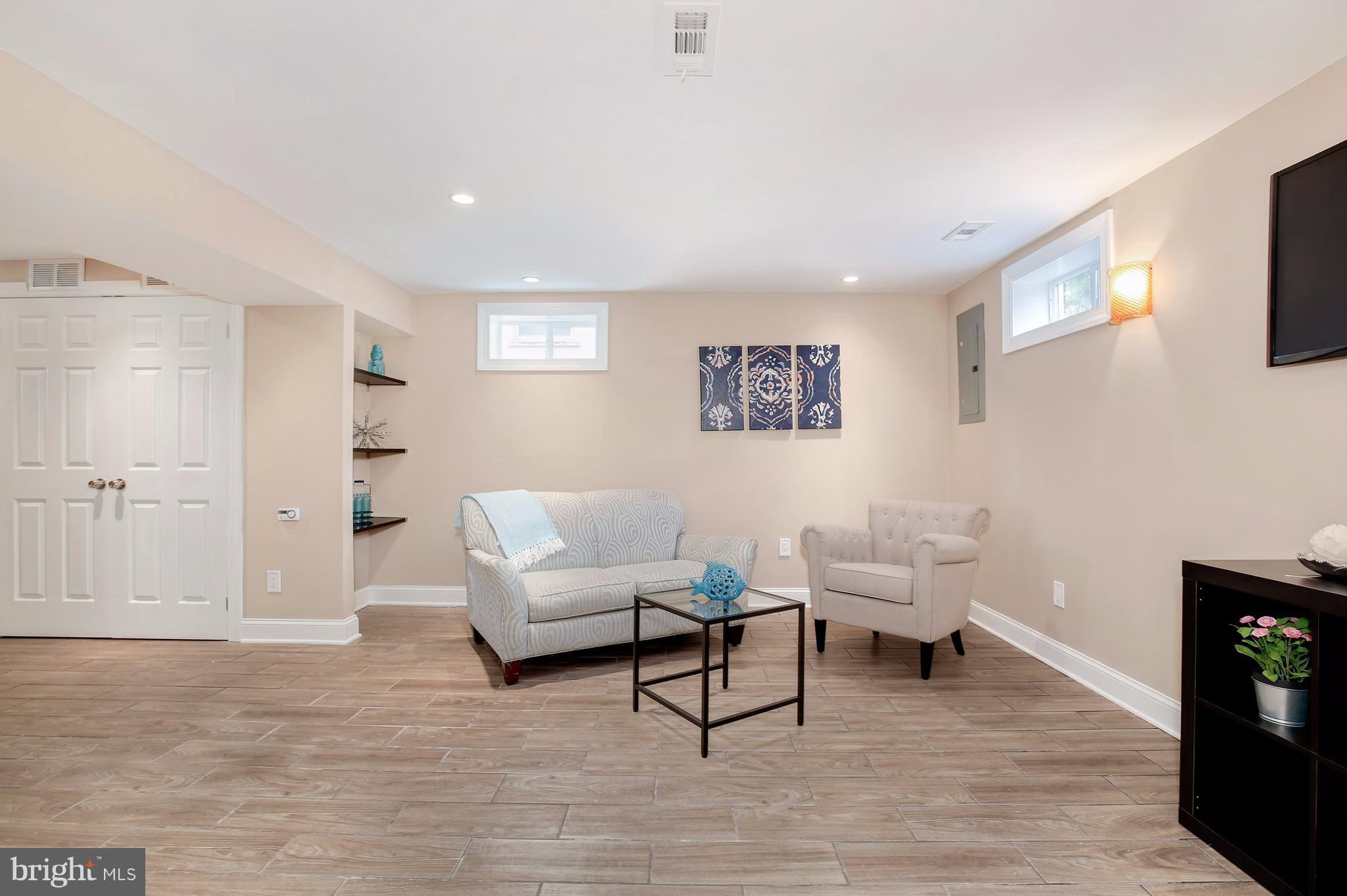 4928 Sargent Road Northeast Washington, DC 20017 - Photo 22 of 30 a living room with furniture and a wooden floor
