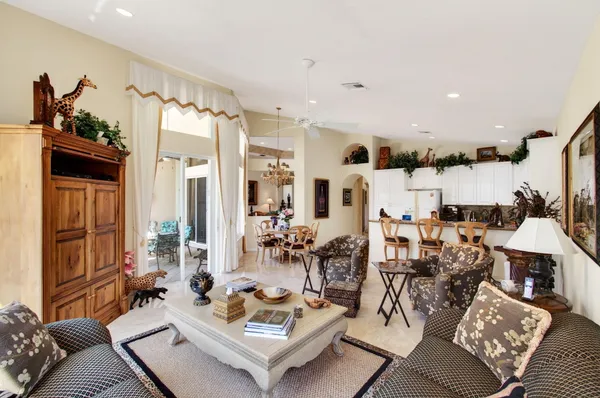a living room with furniture a window and a flat screen tv
