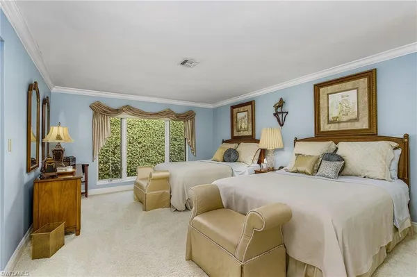 a bed room with two bed and a large window