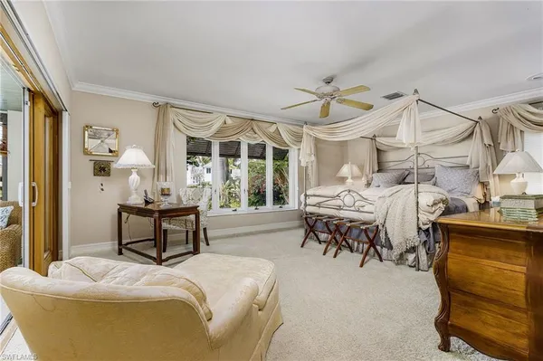 a bedroom with furniture and a large window