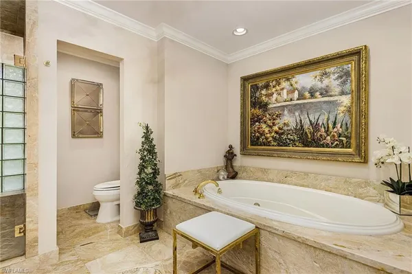 a bathroom with a sink a toilet and a window