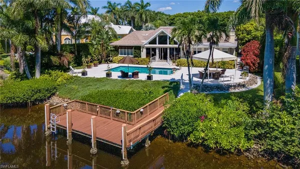 a view of a house with pool and a yard