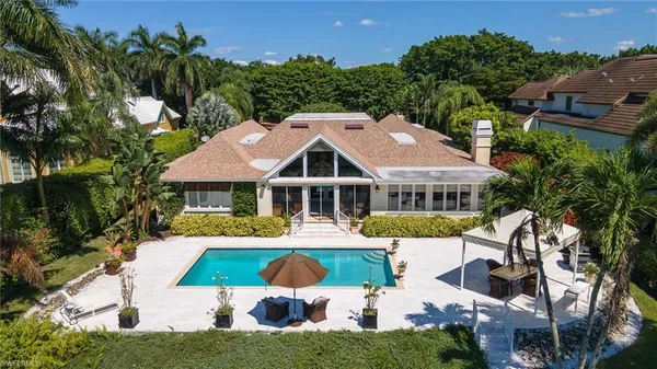a aerial view of a house with a big yard and potted plants