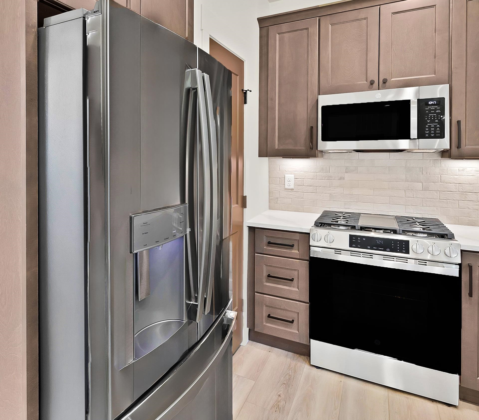 1111 Sprocket Court Fruita, CO 81521 - Photo 16 of 41 a kitchen with stainless steel appliances a stove microwave and refrigerator