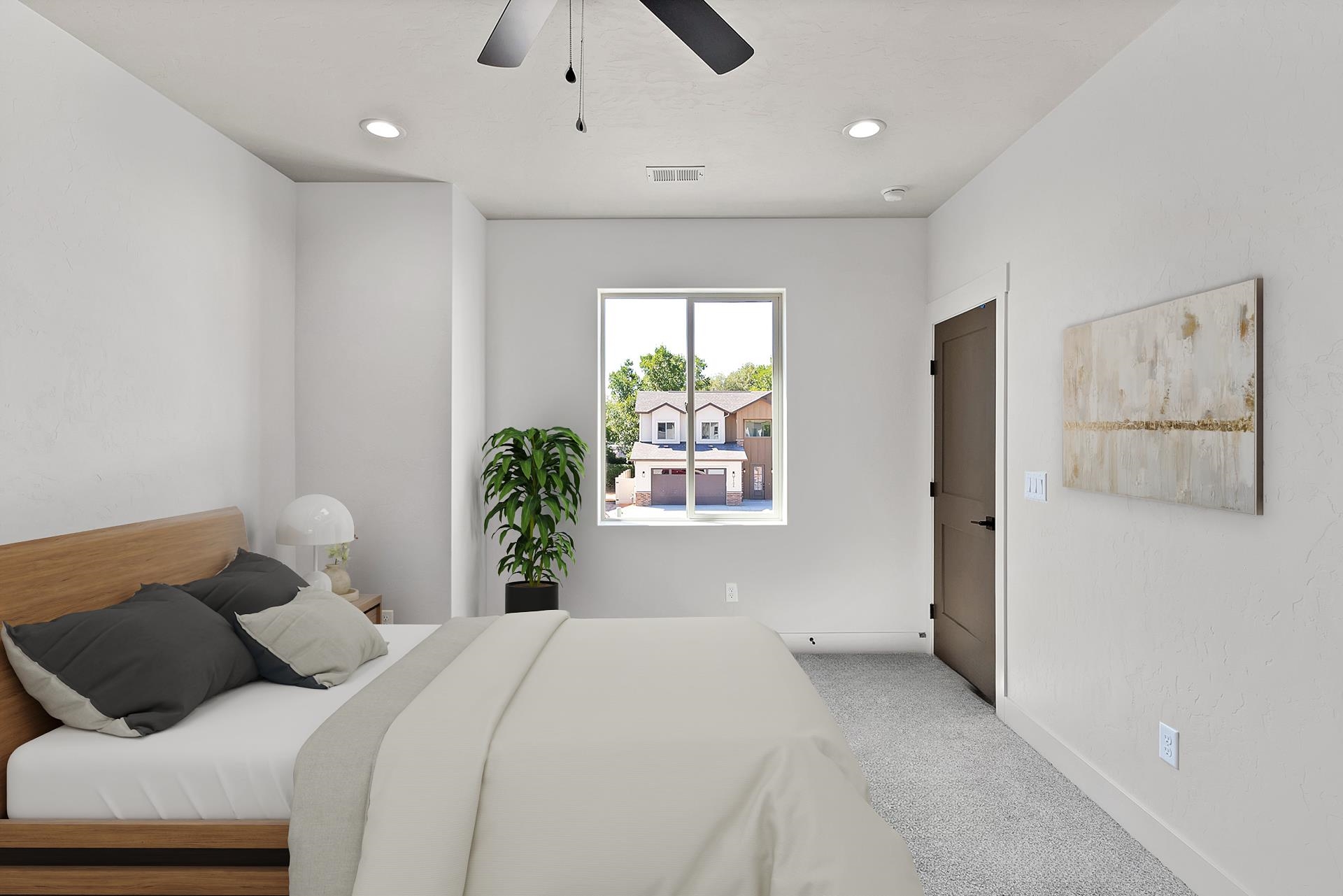 1111 Sprocket Court Fruita, CO 81521 - Photo 25 of 41 a bedroom with a bed and a window