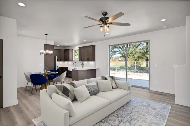 a kitchen with stainless steel appliances a sink a stove a refrigerator a microwave and cabinets