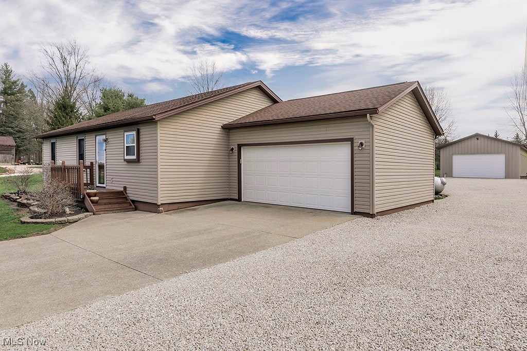 6881 Lake Road Medina, OH 44256 - Photo 27 of 34 Single story home with a shingled roof and concrete driveway