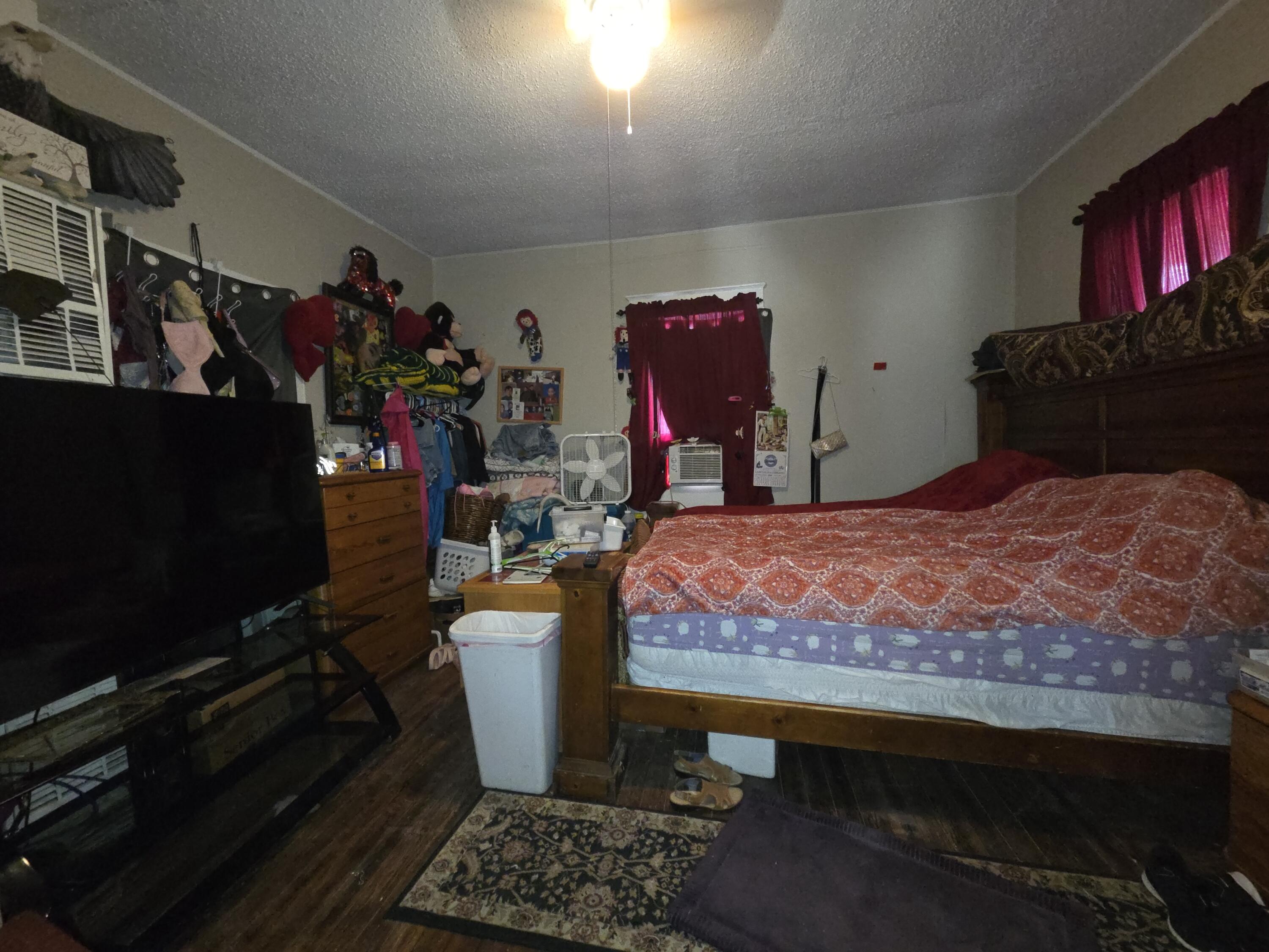 706 29th Street Lubbock, TX 79404 - Photo 2 of 8 a bed room with a bed and a television