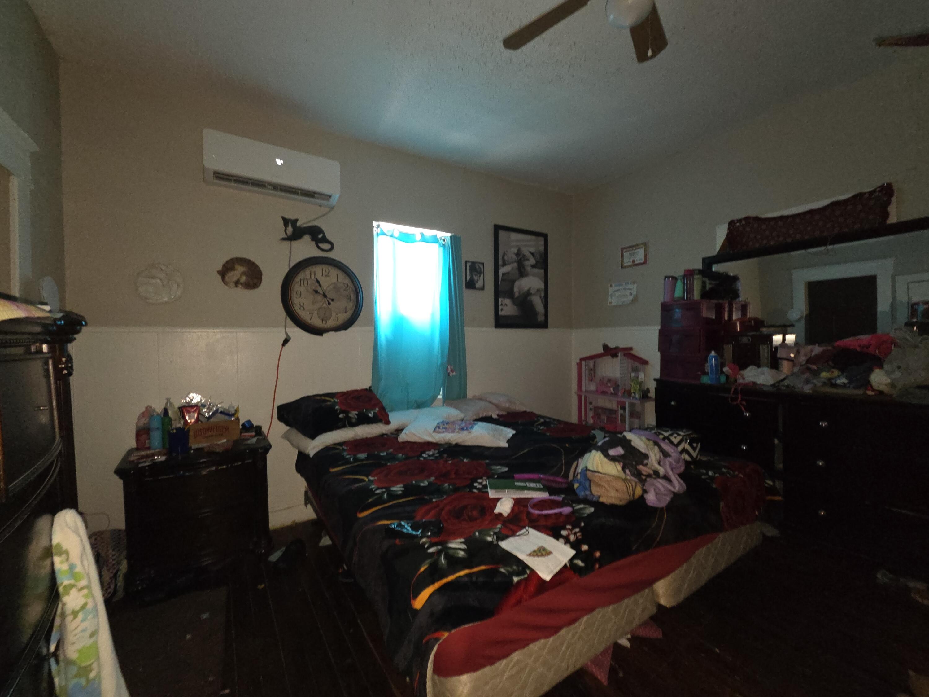 706 29th Street Lubbock, TX 79404 - Photo 6 of 8 a bedroom with furniture and a mirror
