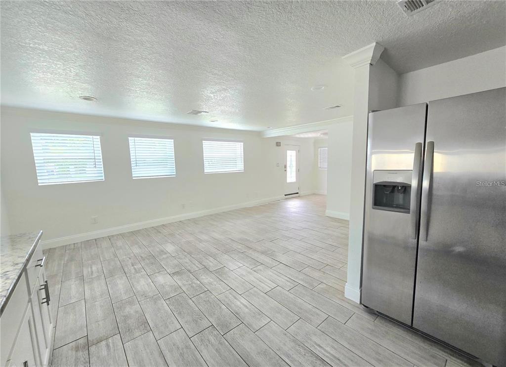 812 High Street Orlando, FL 32803 - Photo 4 of 15 a view of an empty room with wooden floor and a window