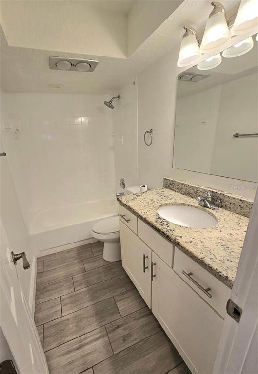 812 High Street Orlando, FL 32803 - Photo 7 of 15 a bathroom with a granite countertop sink toilet and shower