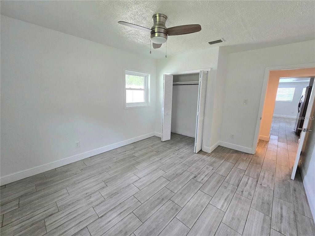 812 High Street Orlando, FL 32803 - Photo 10 of 15 wooden floor in an empty room with a window