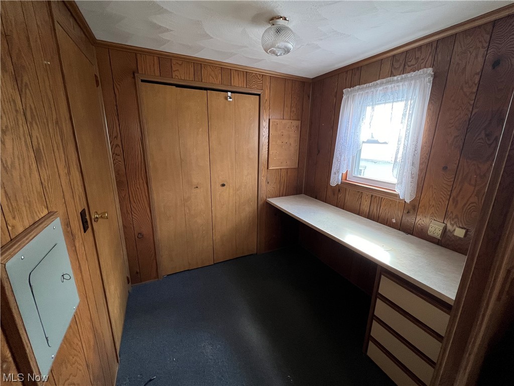 12921 Springfield Road, Unit 3N New Springfield, OH 44443 - Photo 18 of 19 Unfurnished bedroom with wood walls and a closet