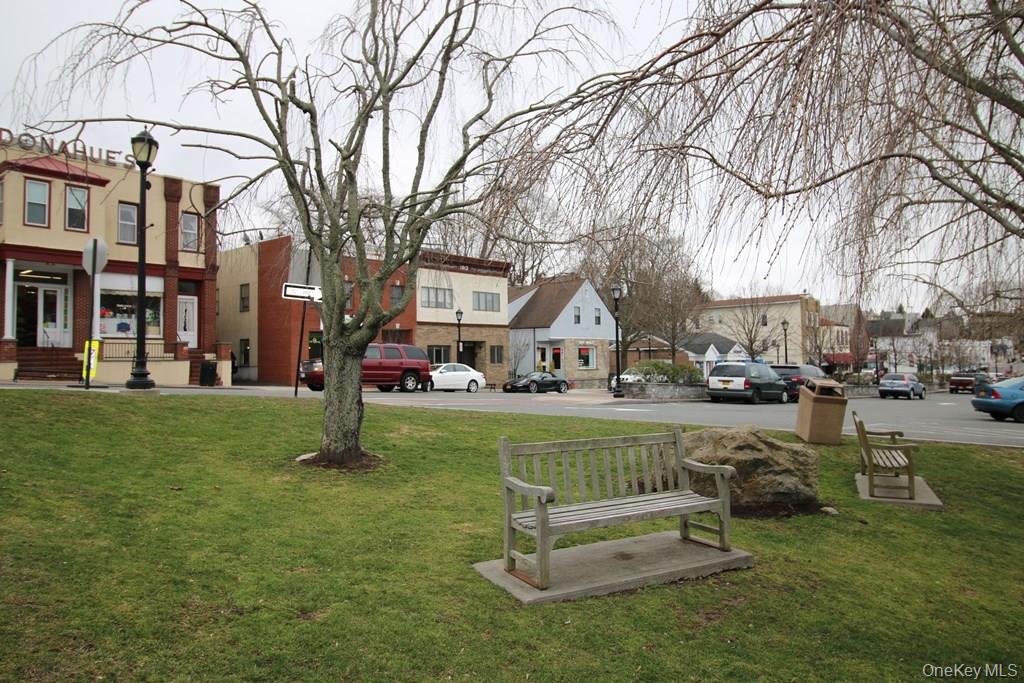 65 Buckout Road West Harrison, NY 10604 - Photo 10 of 11 a front view of a house with a yard table and chairs