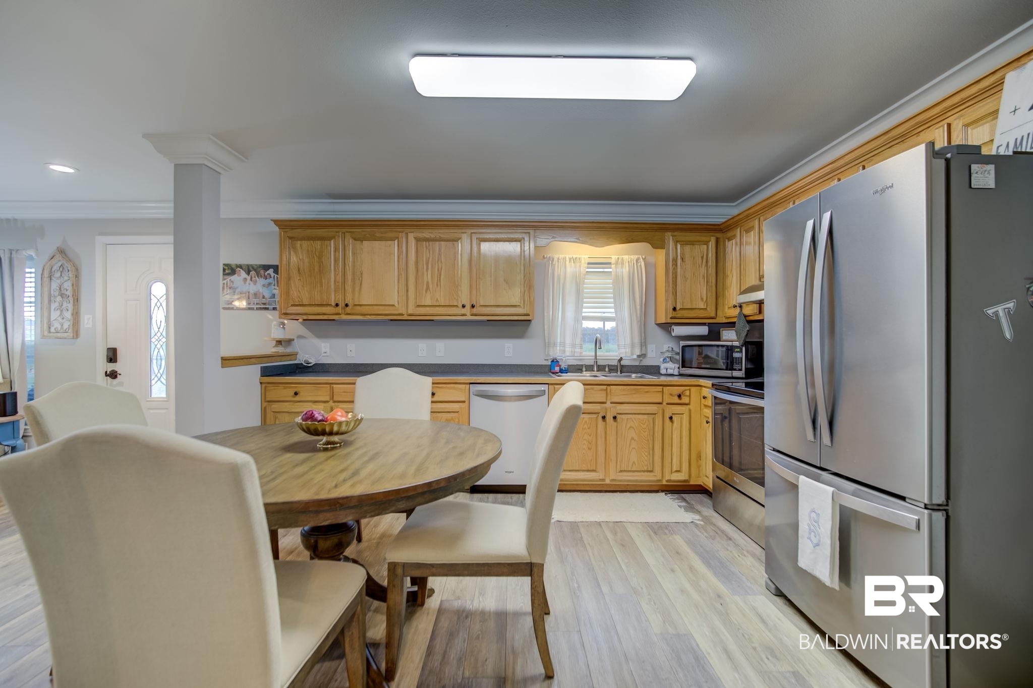 18732 Fairground Road Robertsdale, AL 36567 - Photo 12 of 46 Kitchen with light hardwood / wood-style floors, appliances with stainless steel finishes, crown molding, and sink